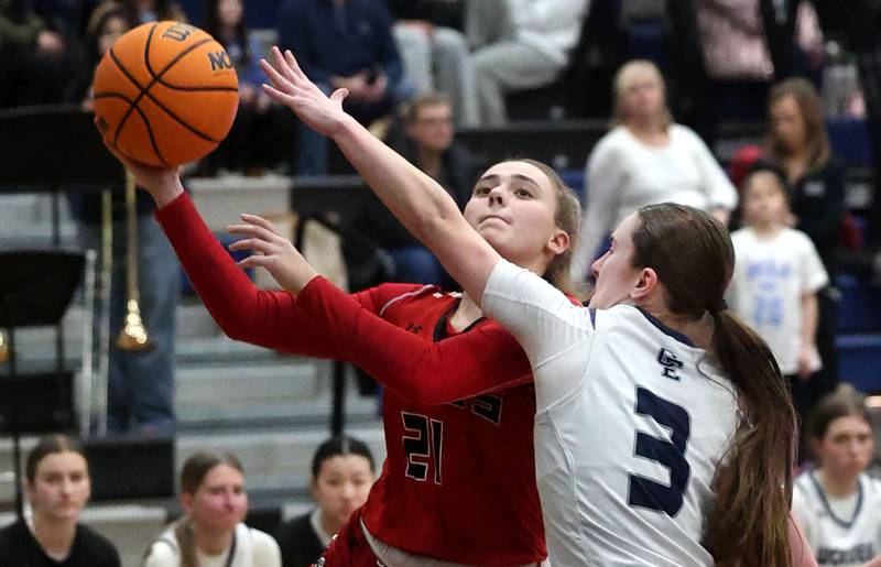 Yorkville's Johanna Pavlak goes to the basket against Oswego East's Maggie Lewandowski during their game Tuesday, Feb. 11, 2025, at Oswego East High School.