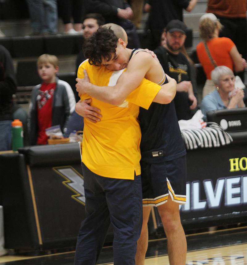Sterling's JP Schilling hugs head coach Ryan Vasquez after the Golden Warriors lost to Metamora 72-70 in the Class 3A Galesburg Sectional semifinals on Wednesday, March 1, 2023.