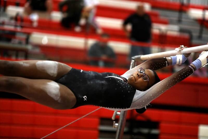 Lincoln-Way East’s April Madison competes on the uneven bars during the Hinsdale Central Sectional on Monday, Feb. 10, 2025 in Hinsdale.