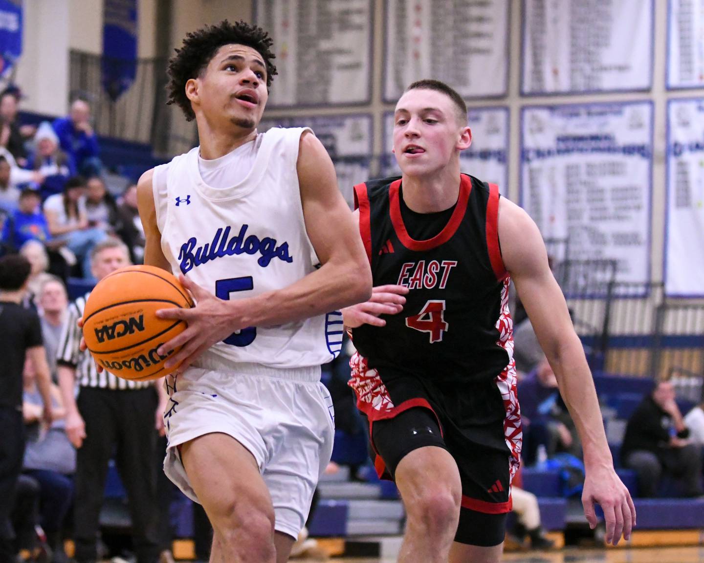 Riverside-Brookfield's Cameron Mercer, left, makes a basket while being defended by Glenbard East's Michael Nee (4) during the game on Tuesday Feb. 3, 2026, held at Riverside-Brookfield High School.