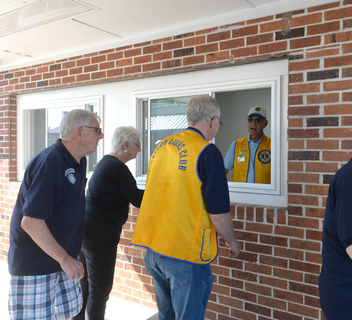 Oregon Lions Grant Afflerbaugh and Tom Champley check out the drive up window at the new Sarah Phelps Community Plaza on Saturday, Sept. 30, 2023. The new plaza will be used in downtown Oregon as a shared venue for community events.