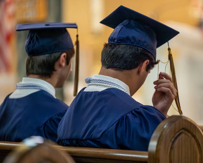 Class of 2026 Marquette Academy Graduate fixes tassel on cap during ceremony on May 24, 2026 at St. Columba Church in Ottawa.