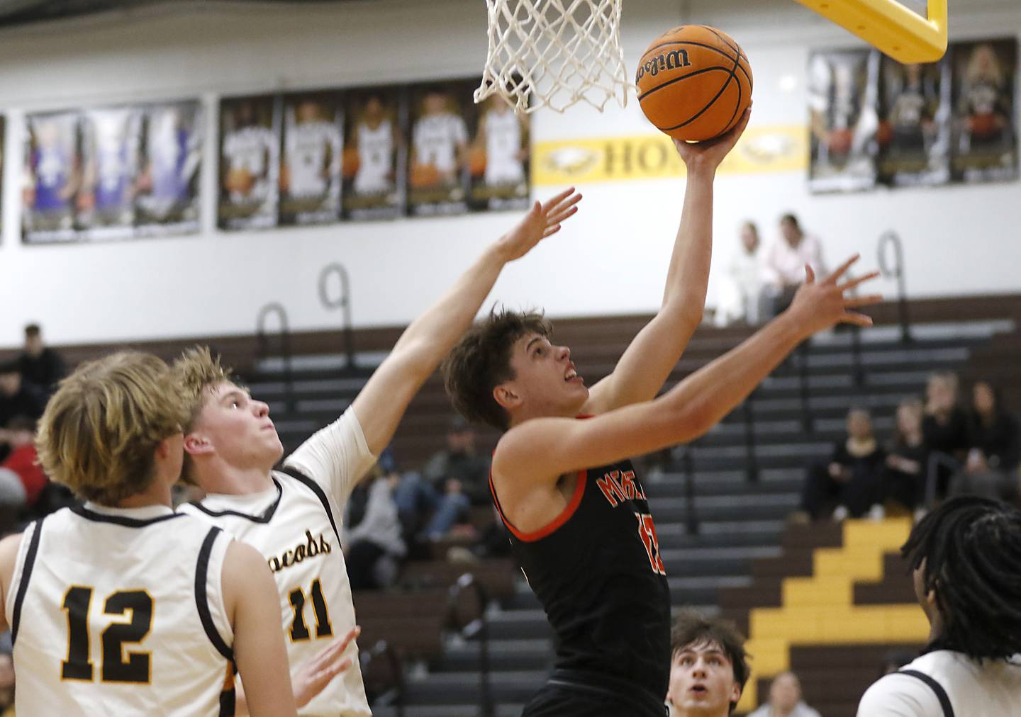 McHenry's Caleb Jett drives tot eh basket against Jacobs' Carson Goehring during a Fox Valley Conference basketball game on Friday, Jan. 24, 2025, at Marian Central High School.