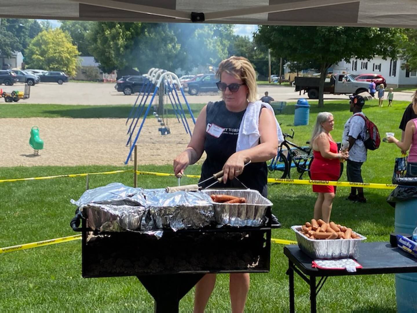 Volunteers grilled hot dogs for lunch Saturday, July 30, 2022, during the Illinois Valley Back-to-School Bash at Hegeler Park in La Salle.