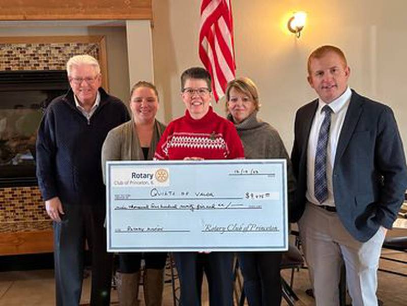 (From left) Steve Bouslog, Ashley Oliver, Terry Johnson, Pam Pratt Marsh and Eric May take part in a check passing from the Princeton Rotary Club to the Illinois Valley Quilts of Valor.