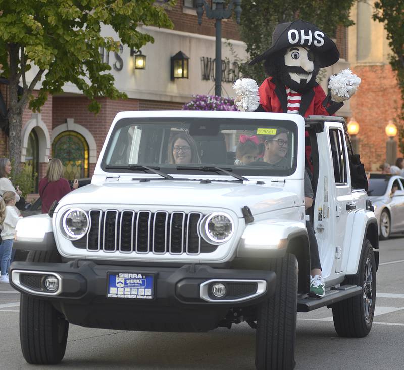 Sudsy the Ottawa High School mascot waves to the crowd along the Homecoming Parade route on La Salle St Wednesday evening in Ottawa.