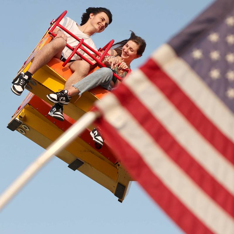 Gavin Hardt, of Belvidere, and Shea Tomlinson, of Genoa, enjoy one of the rides during Genoa Days, Wednesday, June 7, 2023, in downtown Genoa. The festival continues through Saturday.