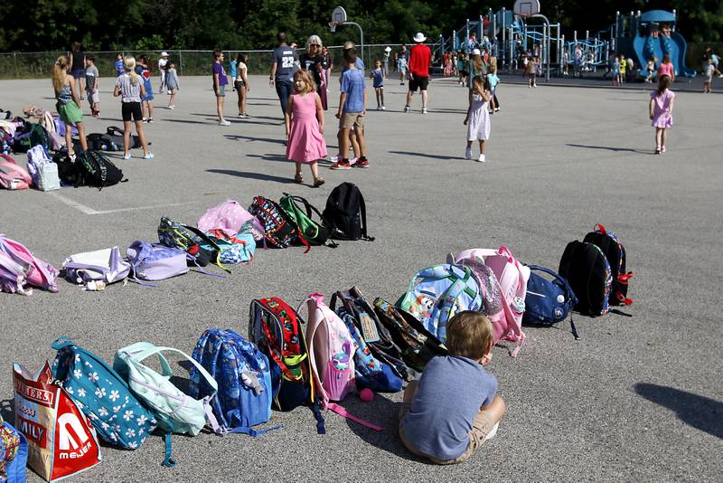 A student watches as his classmates play before the first day of school for McHenry's Landmark Elementary School on Wednesday, July 17, 2024.