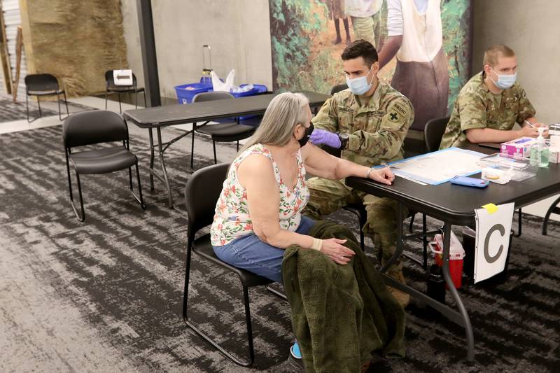 Jacquie Romano of Crystal Lake receives her second dose of the Moderna vaccine during a clinic by the McHenry County Department of Health on Tuesday, May 4, 2021, at Willow Creek Community Church in Crystal Lake.  The clinic began accepting walk-in patients that day.