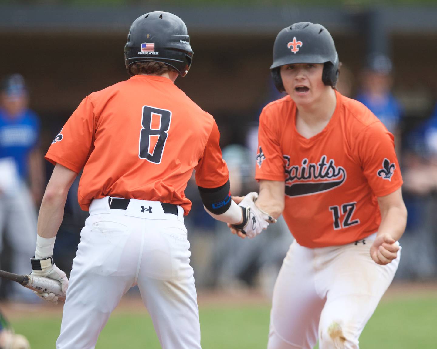 St. Charles East's Jake Greenspan(8) celebrates Jack Bennett (12) scoring a run against St. Charles North on Saturday April 27, 2024 in St. Charles.