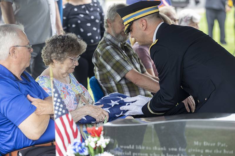 Col. Adam Dietrich presents Janis Rupp-Fischer with the flag that covered her brother Richard Seloover's casket Tuesday, June 4, 2024.
