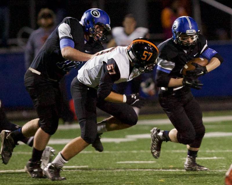 Geneva's Luke Swanson runs for the ball as Bobby Ariss keeps St. Charles East's Michael Gutierrez from making the tackle on Friday in Geneva.