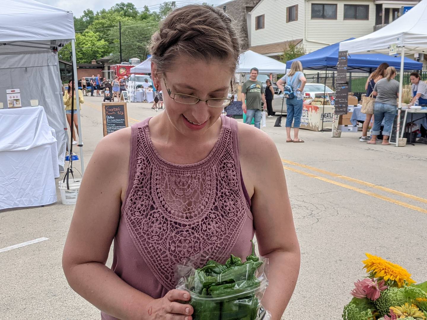 Natasha Lewis of Big Rock Organics looks at some of the organic produce the business sells at the Oswego Country Market.