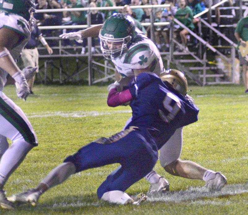 Seneca’s Cam Shriey fights Marquette’s Easton Debernardi as he crosses the goal line to score in the 1st quarter Friday at Marquette.