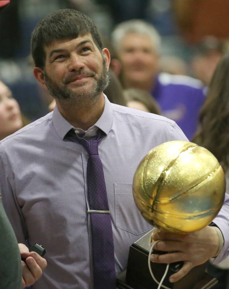 Serena head boys basketball coach Dan Twait smiles as he holds the Little Ten Conference Championship trophy on Friday, Feb. 2, 2024 at Somonauk High School.