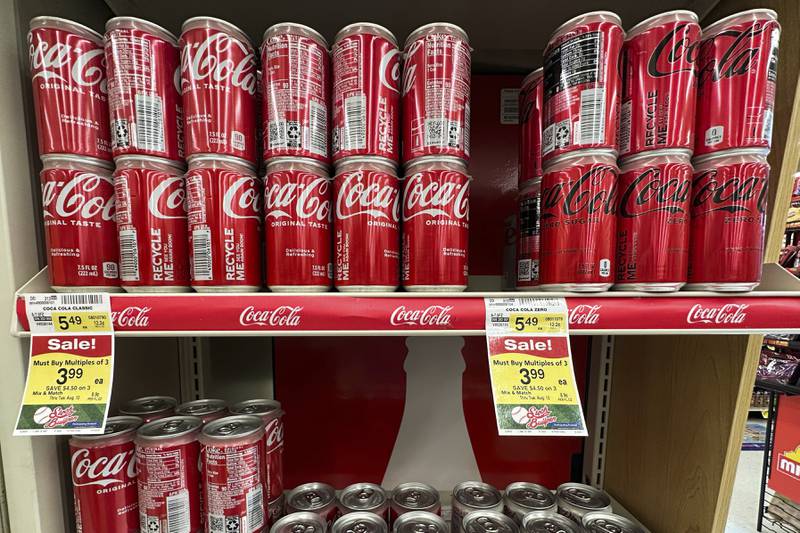 Coca-Cola cans are displayed at a grocery store in Mount Prospect, Ill., Thursday, July 17, 2025. (AP Photo/Nam Y. Huh)