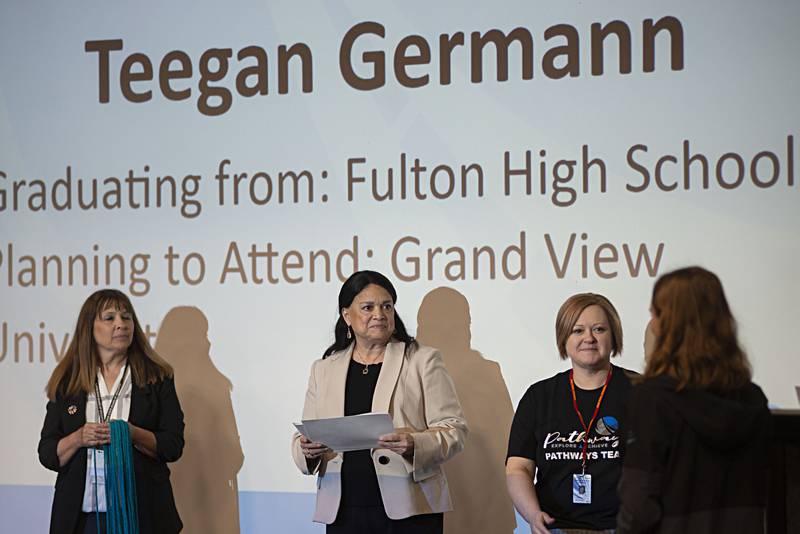 State Superintendent of Education Dr. Carmen Ayala (middle) presents certificates Friday to students who have graduated the Education Pathways program.