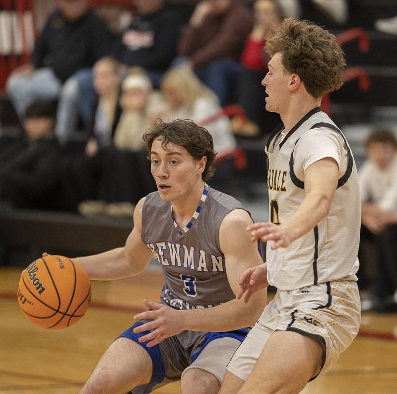 Newman’s Garret Matznick handles the ball against Riverdale’s Colton Clark Tuesday, Dec. 30, 2025, in the final of the boys Cliff Warkins Basketball Tournament at Erie High School.