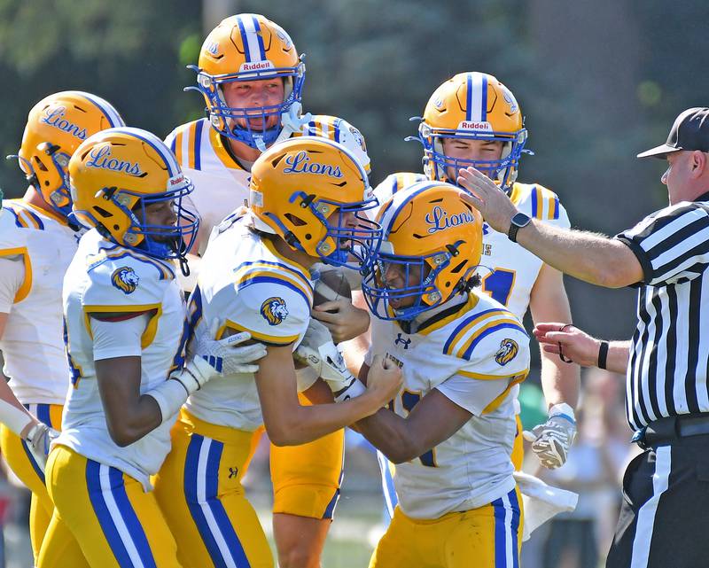 Lyons Township’s Dylan Wolf (middle) is swarmed by teammates after recovering an onside kick during a game against Glenbard West on September 27, 2025 at Glenbard West High School in Glen Ellyn.