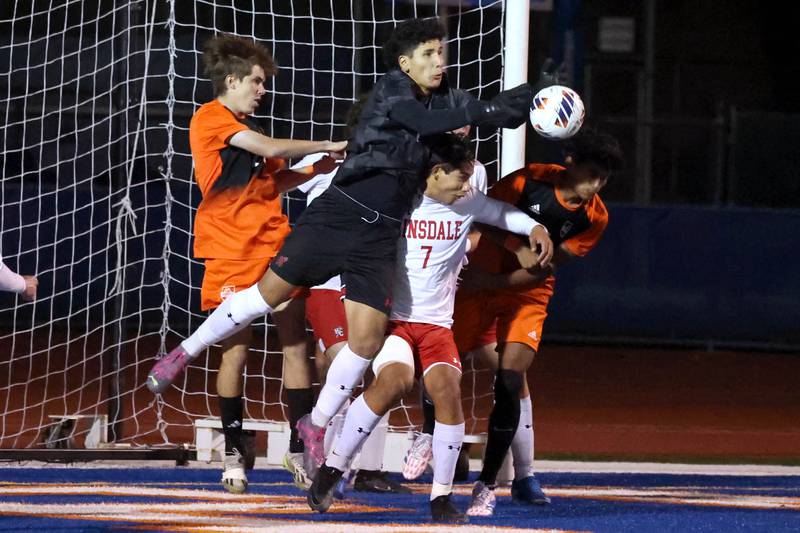 Hinsdale Central's Martin Contreras goes in front of a Hersey player to make a save Friday, Nov. 8, 2024, during their Class 3A state semifinal game at Hoffman Estates High School.