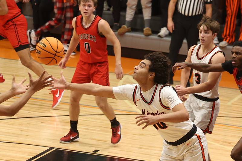 Minooka’s Joe Oyola reaches for the loose ball against Bolingbrook on Tuesday, Dec. 17, 2024 in Minooka.