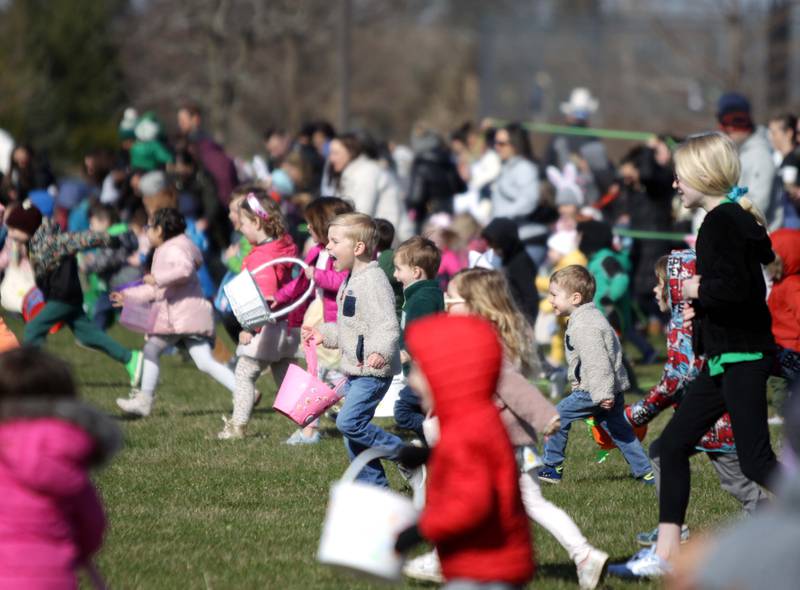 Young participants take off during an egg hunt hosted by the Glen Ellyn Park District at Maryknoll Park on Friday, April 7, 2023.