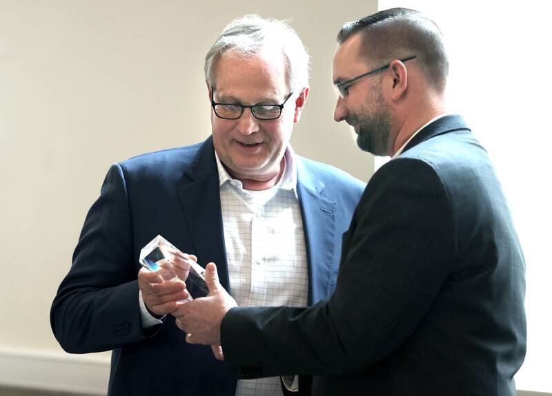 School Tool Box President and CEO Doug Stice (left) accepts the Outstanding Business of the Year award from Robert Heck, outgoing Sycamore Chamber board president, during the 107th Annual Sycamore Chamber of Commerce Meeting Thursday, March 7, 2023, in Memorial Hall at St. Mary's Catholic Church in Sycamore.