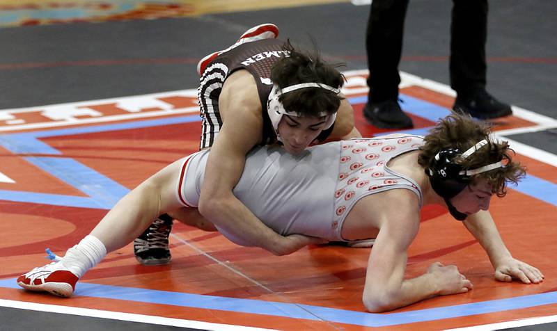 Joliet Catholic's Kane Robles takes down Marian Central's Camden Spiniolas in their 106-pound match during a triangle wrestling meet on Saturday Jan. 11, 2025, between Marian Central, Joliet Catholic, and Mt. Carmel at Marian Central High School in Woodstock.