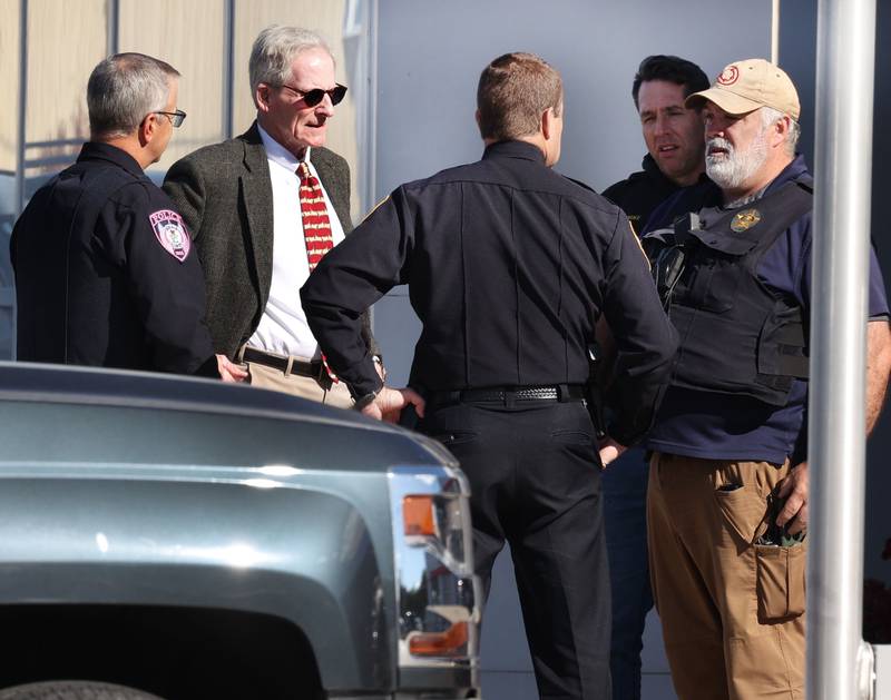 Two women hug among a group of Brian Bemis Toyota employees Wednesday, Oct. 23, 2024, outside the dealership in DeKalb after police responded to a stabbing where multiple employees were injured. The incident ended after police shot the man wielding the knife authorities said.