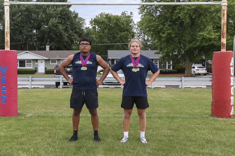 West Aurora's Alphonso Aguilara (L) and Keiran Duncan pose with their medals after the West Aurora "Battle of the Butts" Lineman Challenge, July 10, 2025  in Aurora.