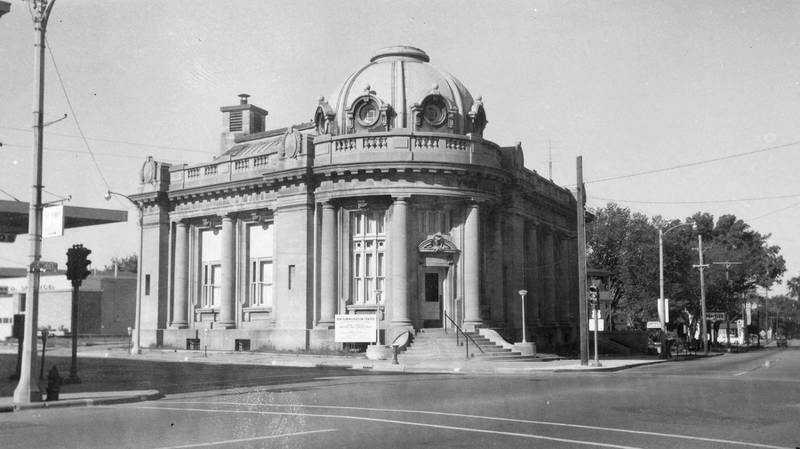 The DeKalb Post Office, looking southwest, at Lincoln Highway and First Street as the building transitions to the administration center for DeKalb School district, October 1960.