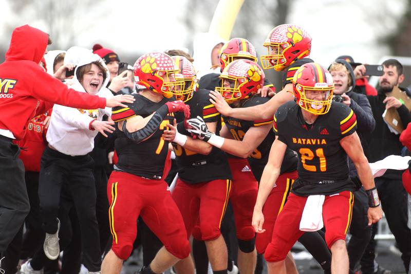 Batavia players celebrate their double overtime win over Hersey in their Class 7A second-round playoff game in Batavia on Saturday, Nov. 5, 2022.