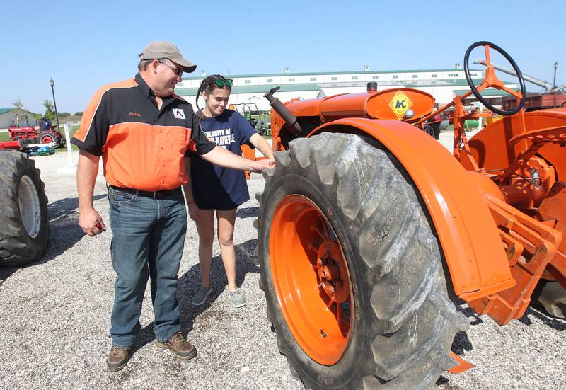 John Dilg, of Pleasant Prairie, Wis., talks with his daughter, Alaina, 18, about his 1936 Allis-Chalmers WC tractor, the first tractor with rubber tires, during the Lake County Farm Heritage & Harvest Festival at the Lake County Fairgrounds on September 23rd in Grayslake. The festival was sponsored by the Lake County Farm Heritage Association.
Photo by Candace H. Johnson for Shaw Local News Network