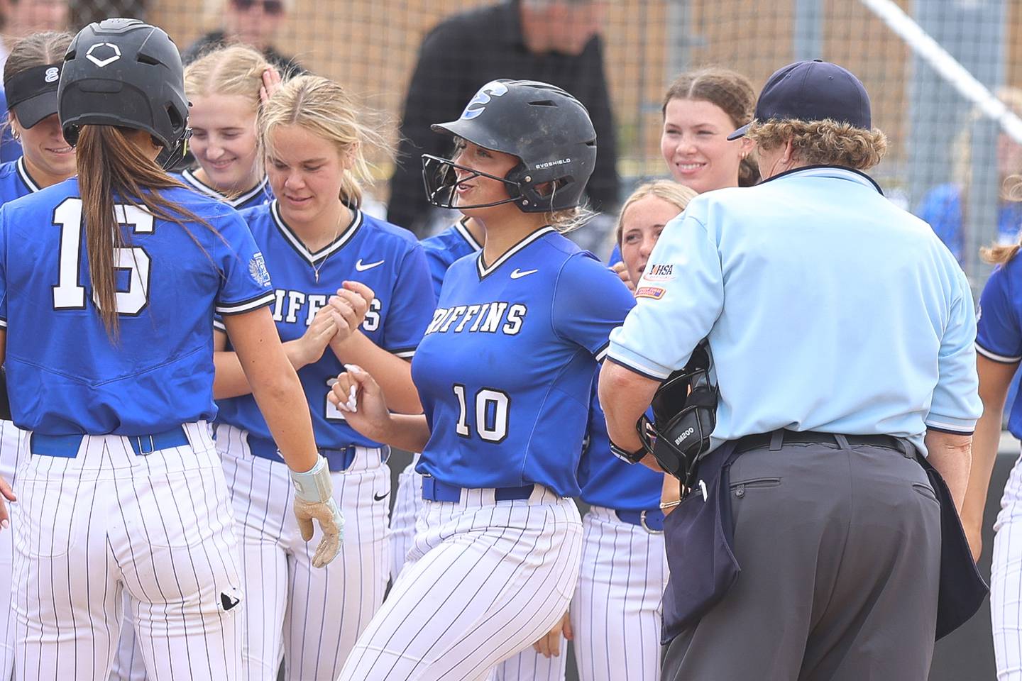 Lincoln-Way East’s Maddie Henry is greeted at the plate after a grand slam against T.F. South in the Class 4A Lincoln-Way East Regional semifinal on Tuesday, May 19, 2026 in Frankfort.