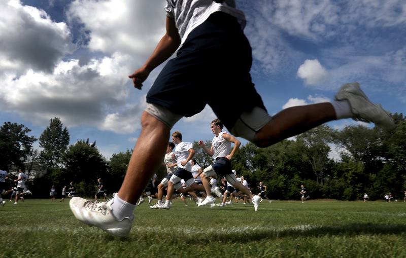 Cary-Grove players runs the field during their first football practice of the upcoming season on Monday, August 11, 2025, at Cary-Grove High School.