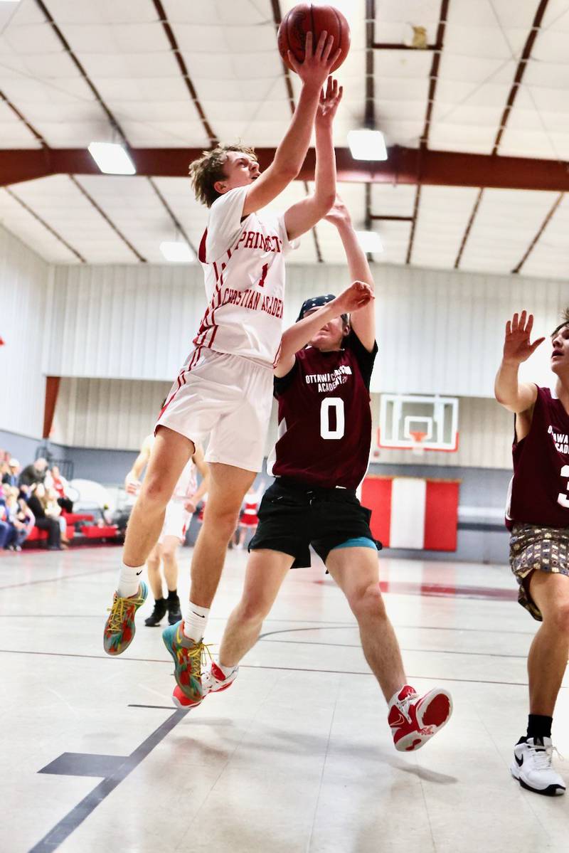 Princeton Christian Academy's Julian Mucha shoots Tuesday over Ottawa Christian Academy's Harlan Hetelle at Howard Hoffman Memorial Gym. The Eagles won 57-42.
