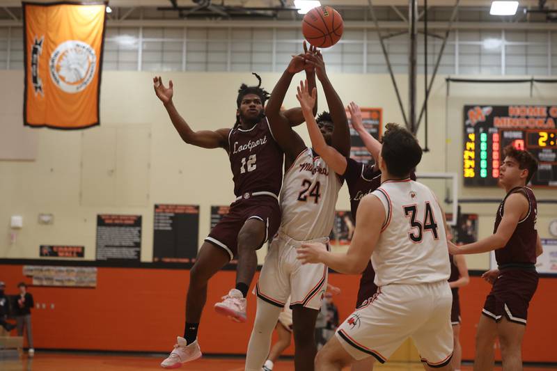 Lockport’s Jalen Falcon, 12, and Minooka’s Micah Hamilton, 24, battle for the rebound.