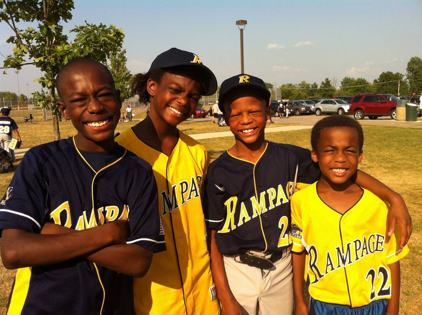 Brendon, Kayla, Justin and Damon pose after a day of baseball and softball.