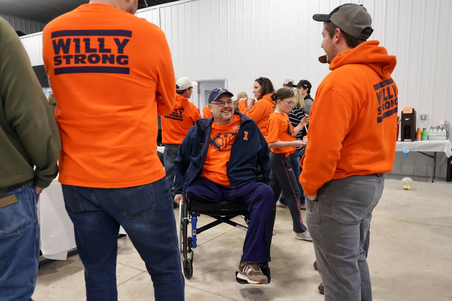 Willy VanWassenhove laughs while visiting with friends and family during a welcome home event at the Cabery Fire Department upon his return home to the area on Saturday, March 22, 2025.