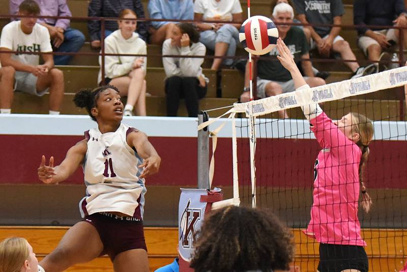 Kankakee's Shania Johnson, left, watches her hit attempt hit the fingertips of Bradley-Bourbonnais' Samantha Harsy during All-City action at Kankakee Tuesday, Sept. 9, 2025.