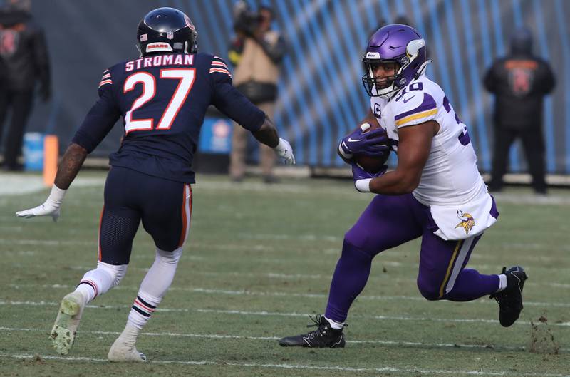 Minnesota Vikings fullback C.J. Ham looks to get by Chicago Bears cornerback Greg Stroman Jr. Sunday, Jan. 8, 2023, during their game at Soldier Field in Chicago.