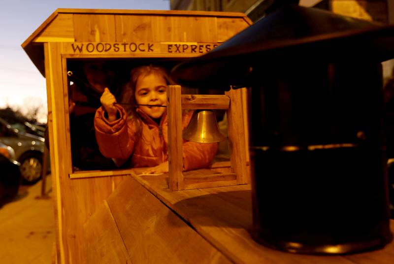 Delilah Fisher, 4, of Lake in the Hills, rings the train bell during the Lighting of the Square Friday, Nov. 25, 2022, in Woodstock. The annual event featured brass music, caroling, free doughnuts and cider, food trucks, festive selfie stations and shopping.