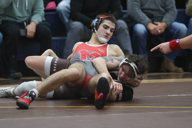 Marian Central’s Vance Williams works over Mt. Carmel’s Damion Resndez in the tri-meet at Joliet Catholic on Thursday, Jan. 18th, 2024 in Joliet.