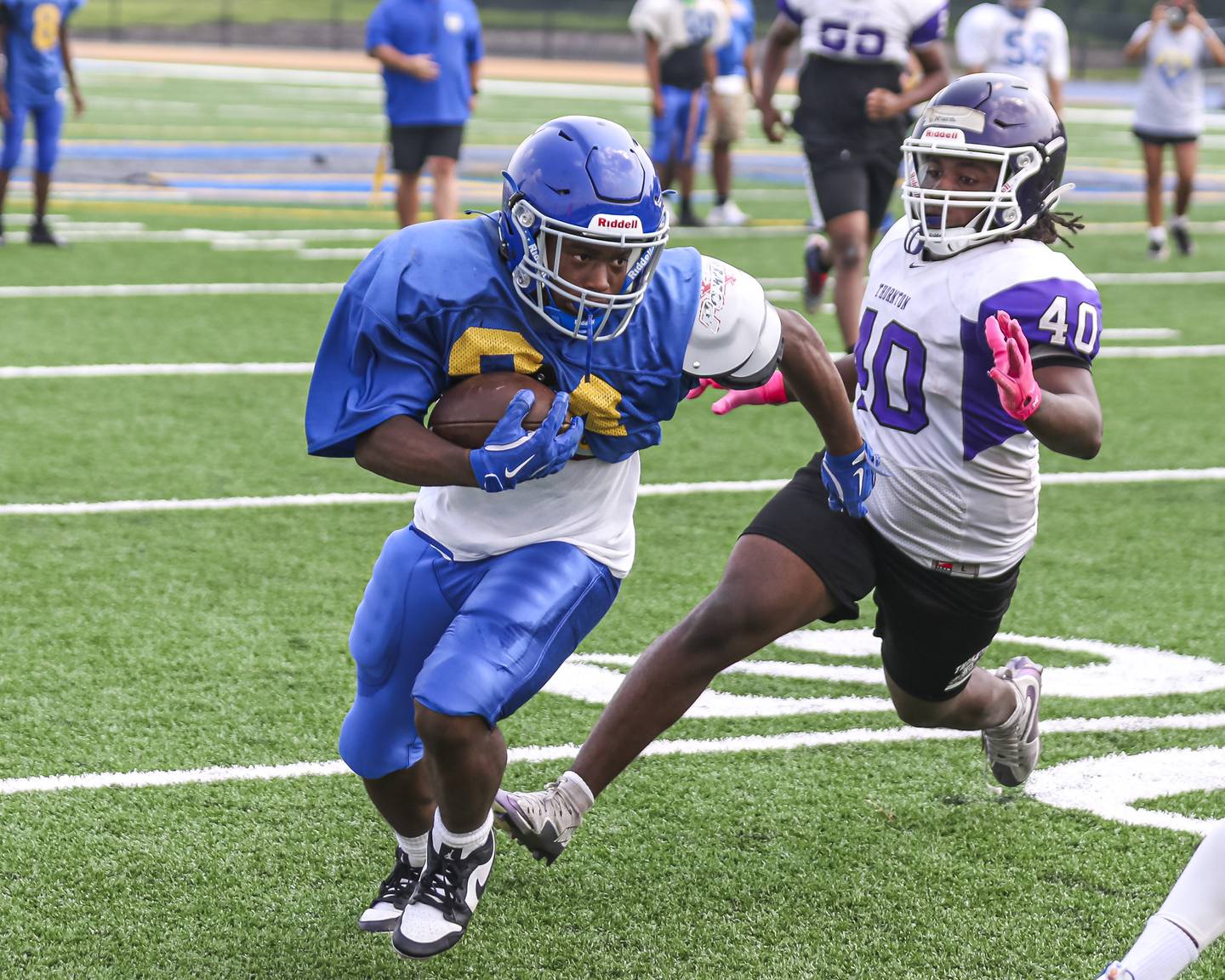 Tristen Sellers beats the defender to the edge after catching a short pass during Joliet Central's joint practice with Thornton, July 31, 2025 in Joliet.