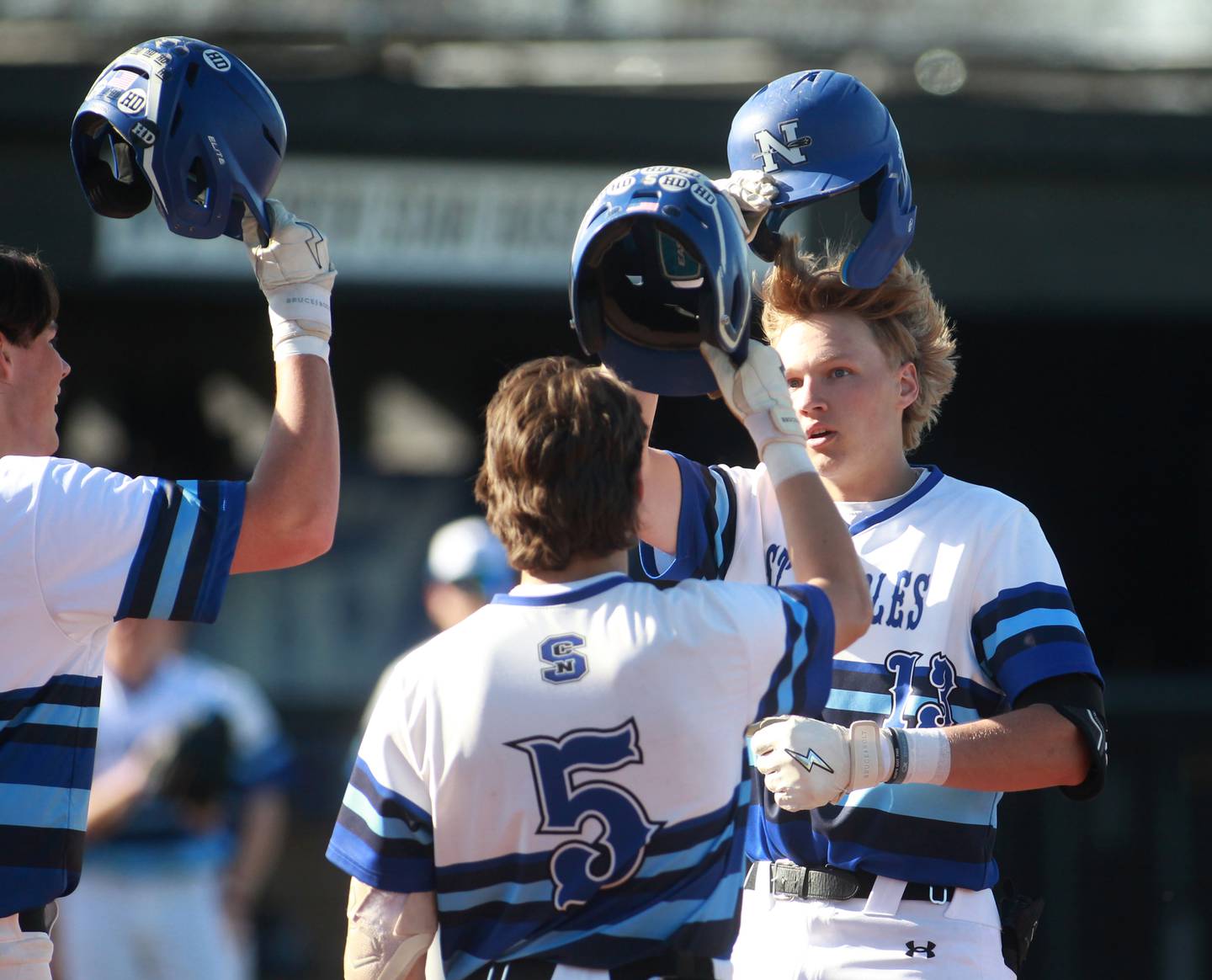 St. Charles North’s Parker Reinke (far right) crosses home plate after hitting a home run during a game aganst Batavia at St. Charles North on Monday, April 15, 2024.