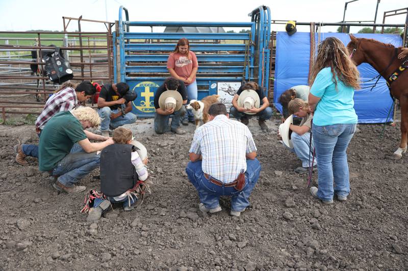 Matt Wright, center, begins practice with a prayer with Dominic Dubberstine-Ellerbrock and his other students. Dominic will be competing in the 2022 National High School Finals Rodeo Bull Riding event on July 17th through the 23rd in Wyoming. Thursday, June 30, 2022 in Grand Ridge.