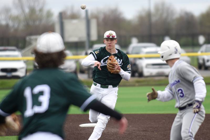 Coal City's Dylan Young, center, throws to Hayden Clark, left, as the Coalers have Wilmington's Shawn James in a pickle during a game at Coal City Monday, April 21, 2025.