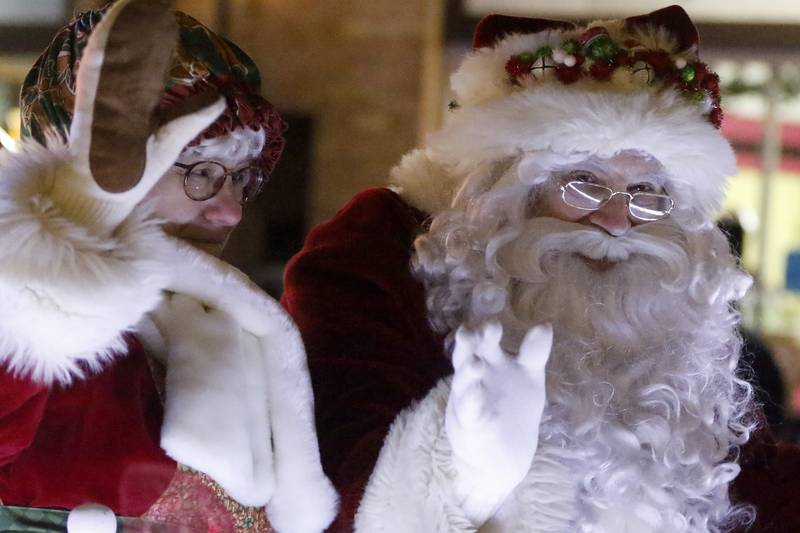 Santa and Mrs. Claus wave to children as they pass by during the annual Festival of Lights Parade on Friday, Nov. 26, 2021, in downtown Crystal Lake.