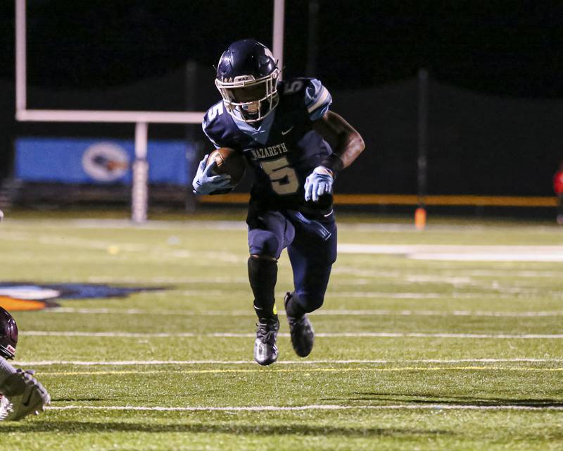 Nazareth Academy's Kaleb Miller (5) runs up the middle during football game between Montini at Nazareth Academy Oct 15, 2021.