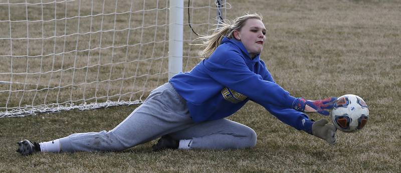 Johnsburg goalkeeper Sophie Person makes a diving save during soccer practice Wednesday, March 8, 2023, at Johnsburg High School.